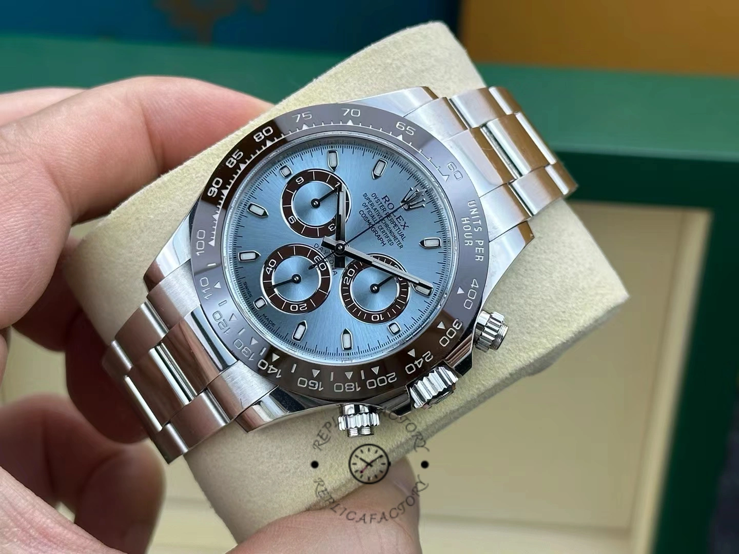 Hand-held angled view of the Rolex Daytona 116506 showing ice-blue dial and platinum bracelet.