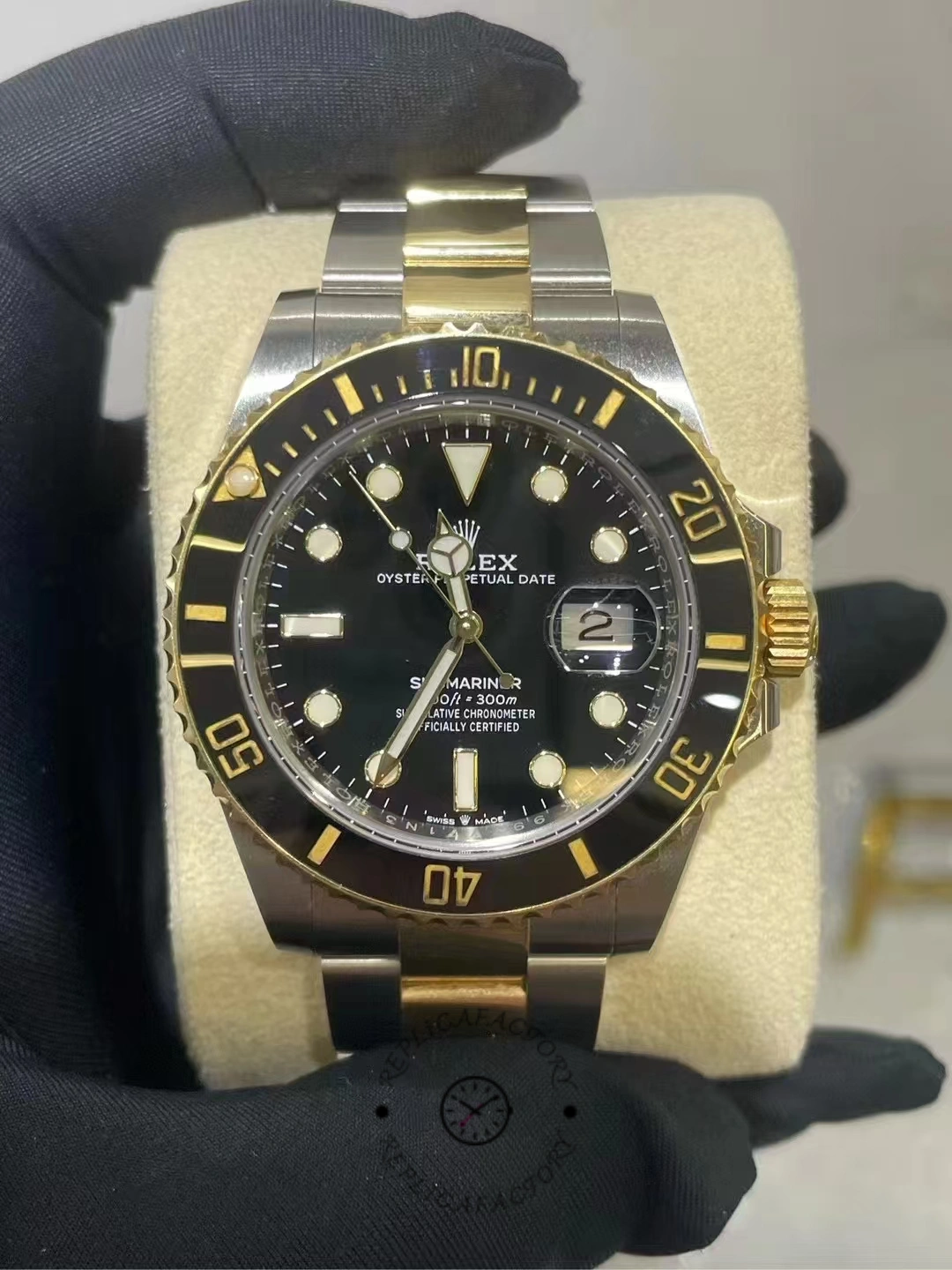 Front view of a worn Rolex Submariner 126613LN-0002 after two years of use, showing black dial and gold bezel accents
