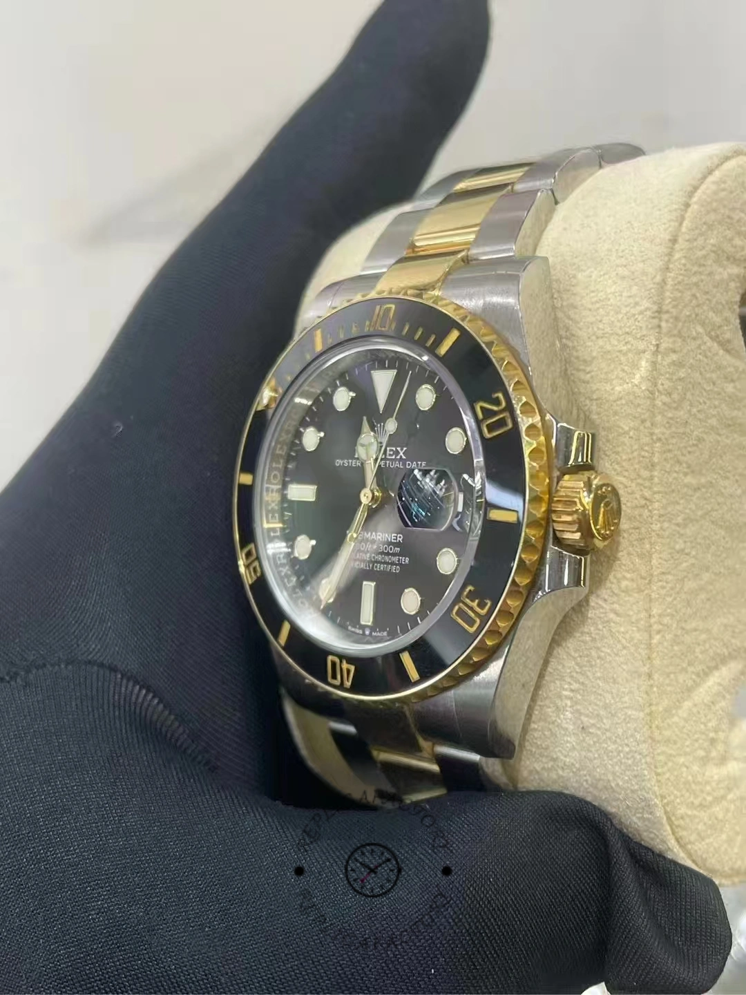 Side view of a used Rolex Submariner 126613LN-0002 showing the gold crown and ceramic bezel