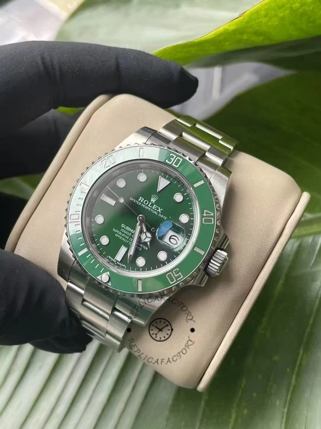 Angled view of Rolex Submariner Date 116610LV showing stainless steel bracelet and green ceramic bezel.