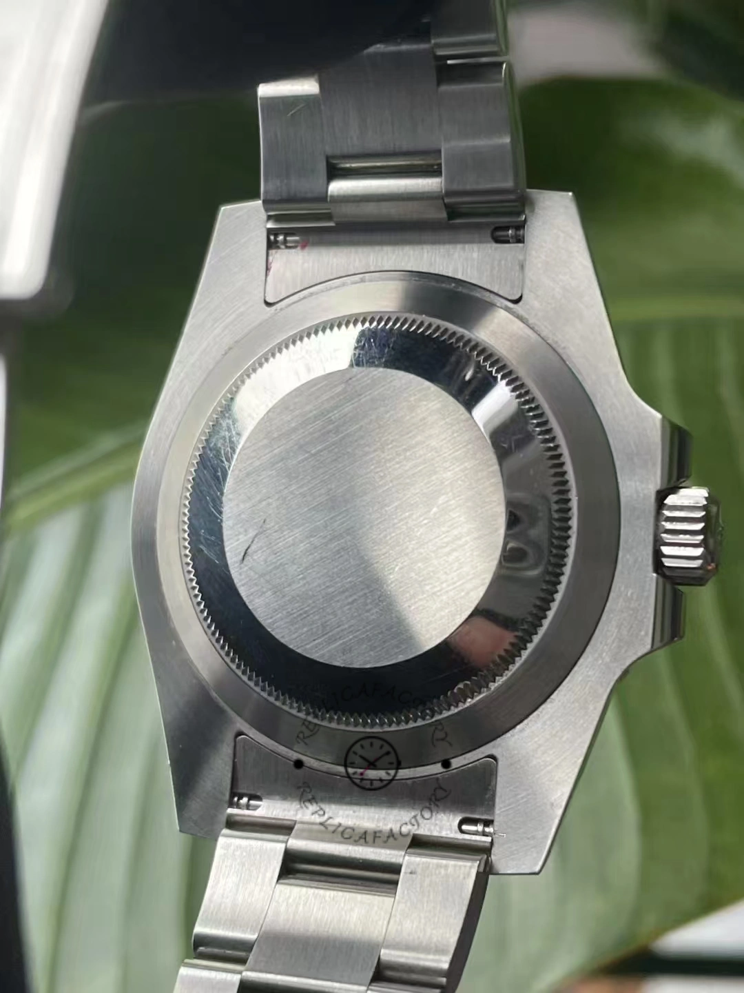 Caseback view of Rolex Submariner Date 116610LV showing brushed steel finish and screw-down back.