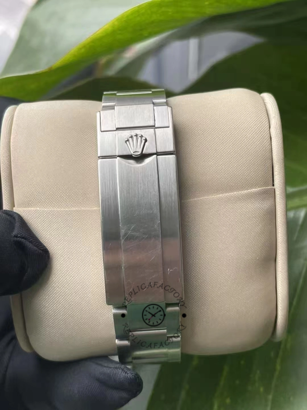 Rear clasp of Rolex Submariner Date 116610LV with engraved Rolex crown on brushed steel surface.