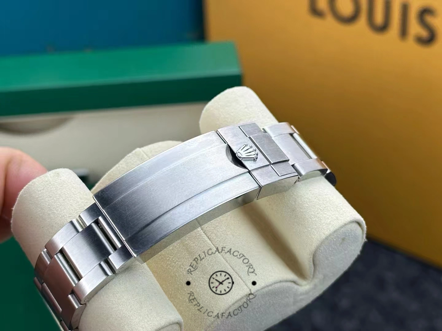 Bracelet clasp of used Rolex Submariner 126610LV showing worn brushed finish.