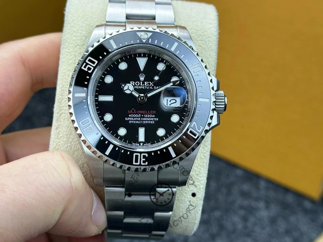 Close-up of Rolex Sea-Dweller 126600-0002 showing black dial, ceramic bezel, and luminous hour markers.