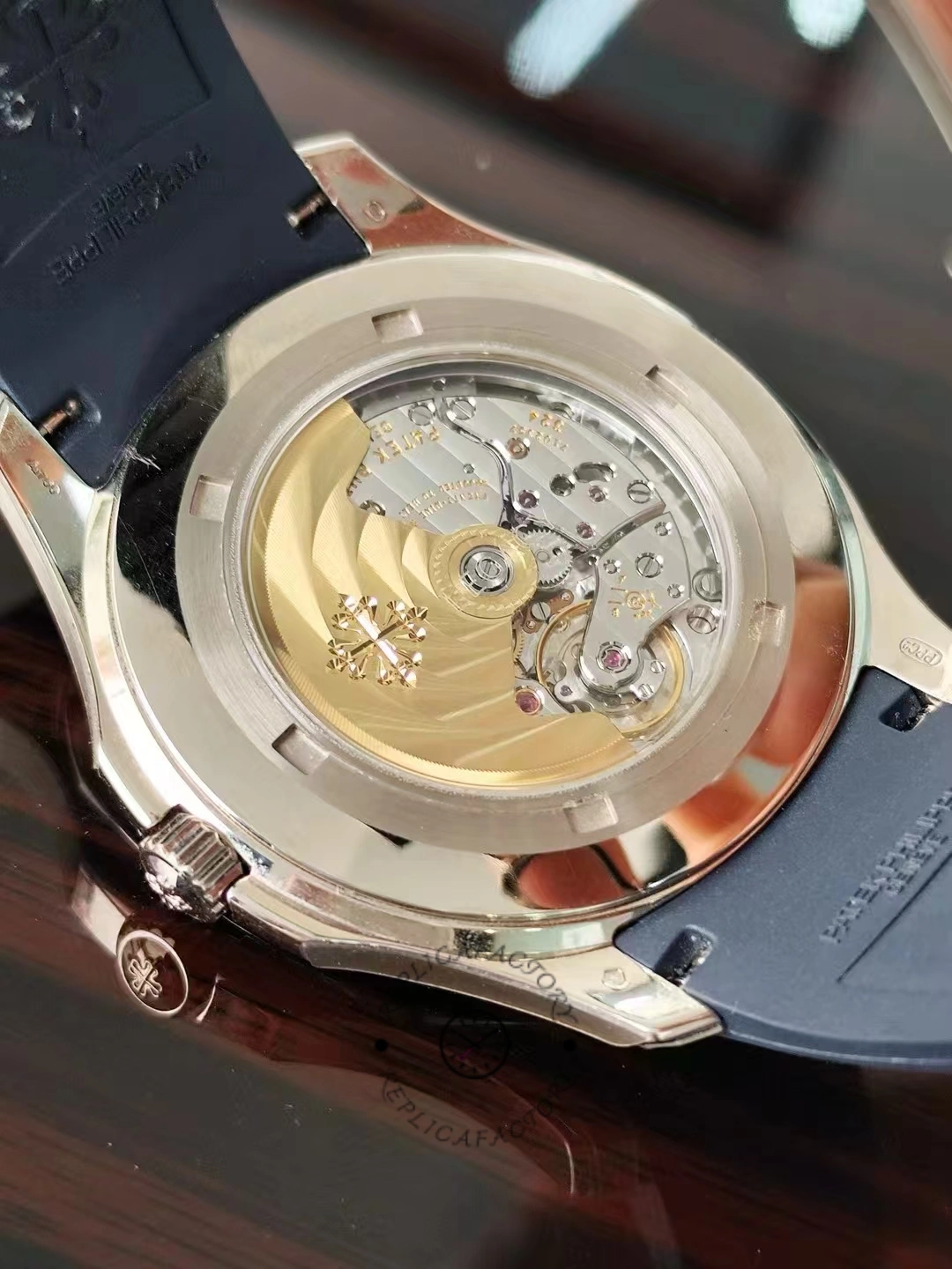 Exhibition caseback of the Patek Philippe Aquanaut 5164G-001 revealing the rotor and movement details.