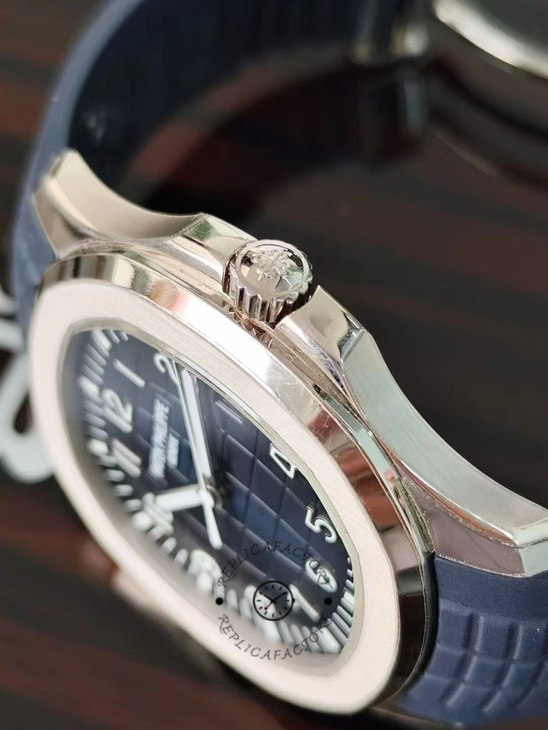 Profile shot of the Patek Philippe Aquanaut 5164G-001 showing the brushed case and curved lugs.