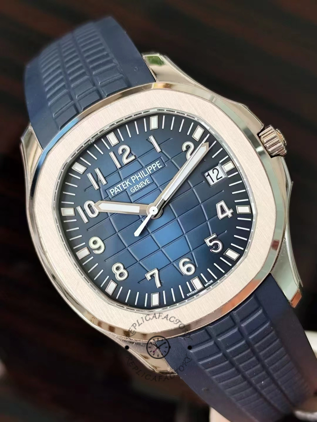 Close-up of the Patek Philippe Aquanaut 5164G-001 showing its blue textured dial and rubber strap.