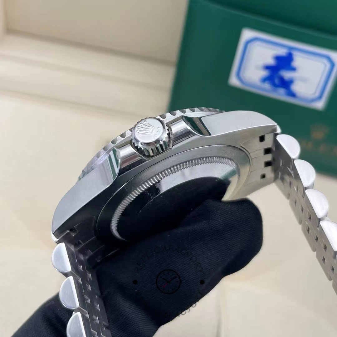 Side angle of Rolex GMT-Master II 126710BLRO showing crown with Rolex logo and polished case.