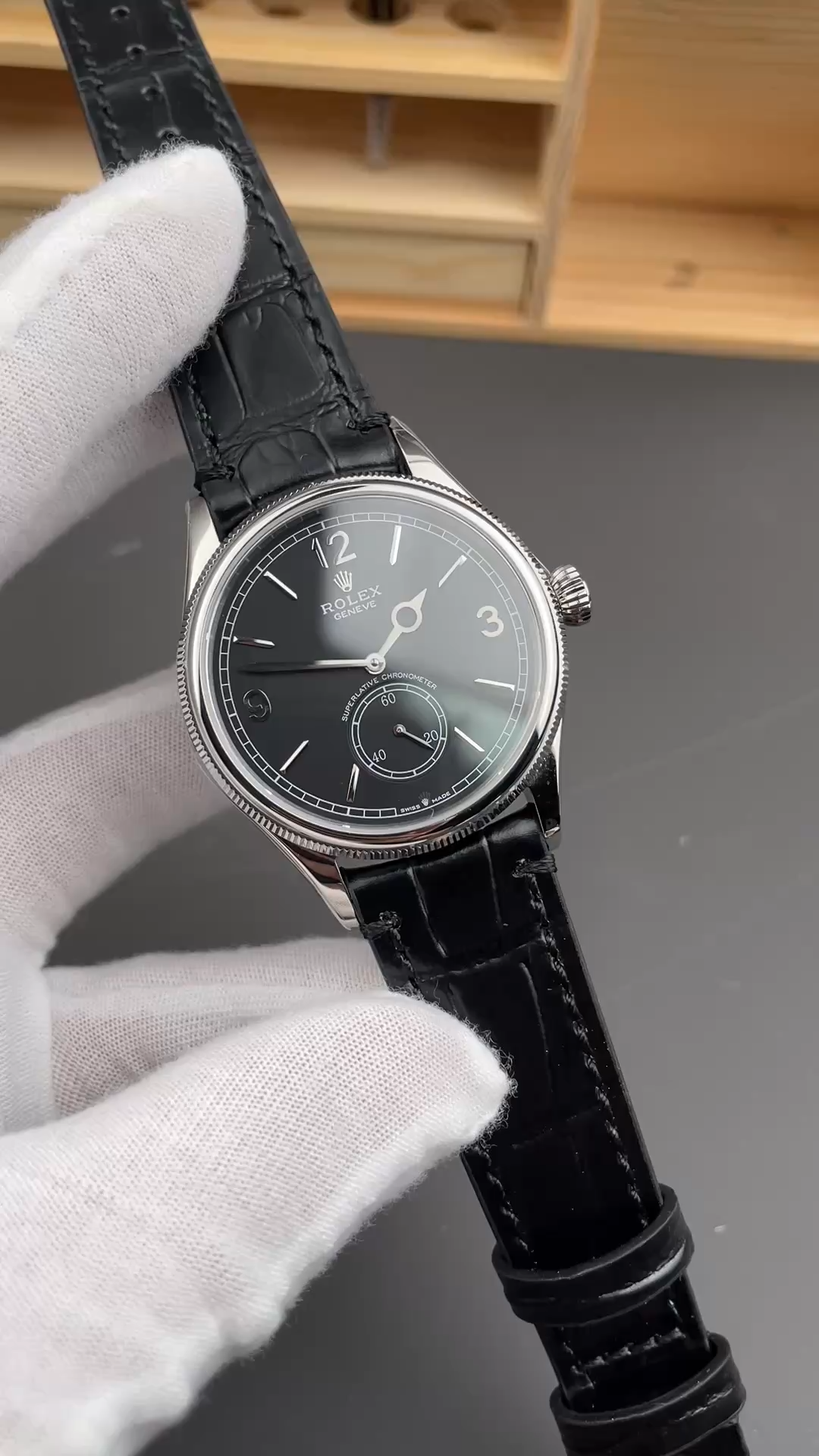 Video of Rolex 1908 Black Dial 52509-0002 39mm replica showing black leather strap held in hand.