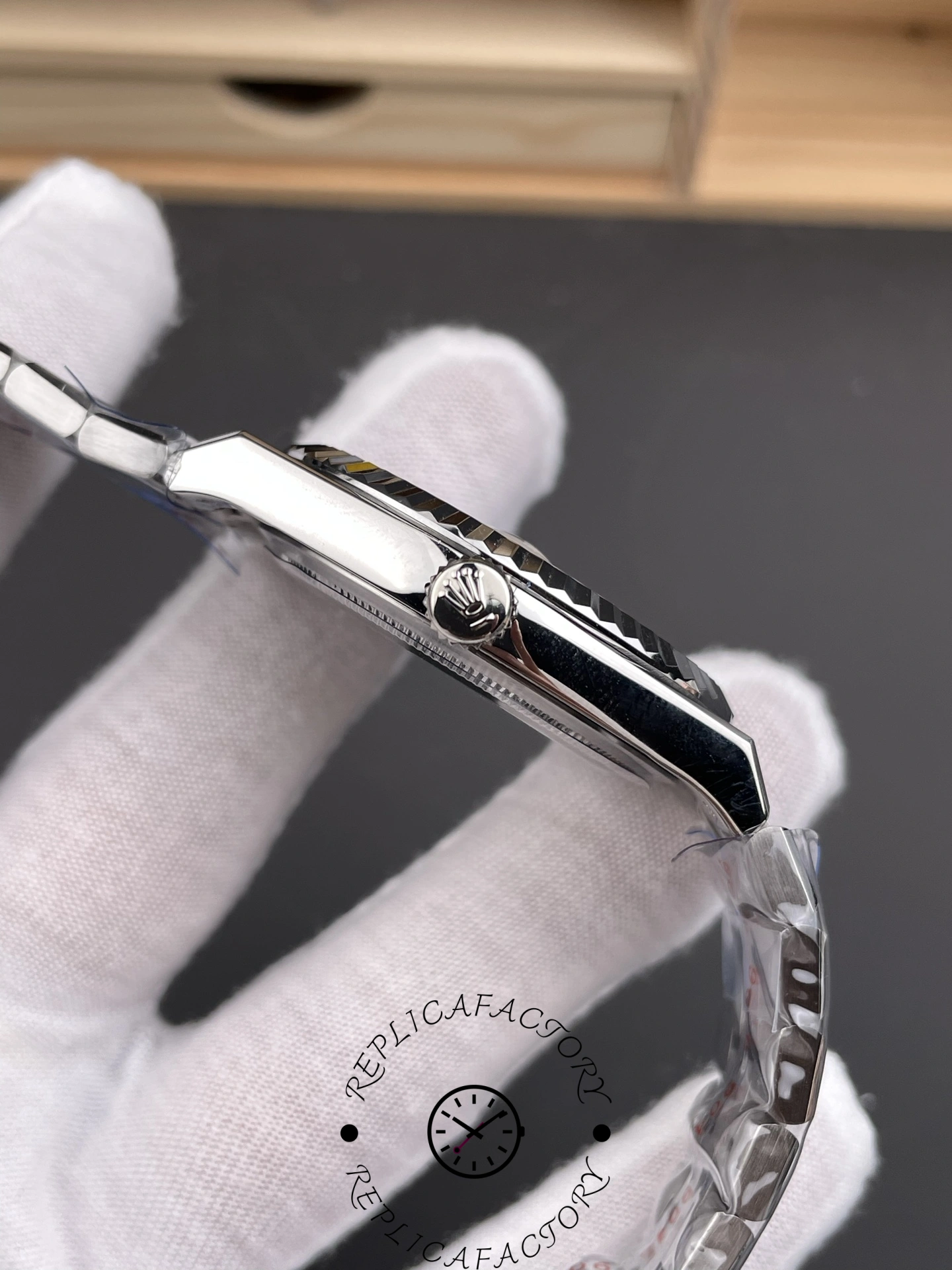 Side view of Rolex Land-Dweller 40 M127334-0001 Replica highlighting smooth case side and crown guards.