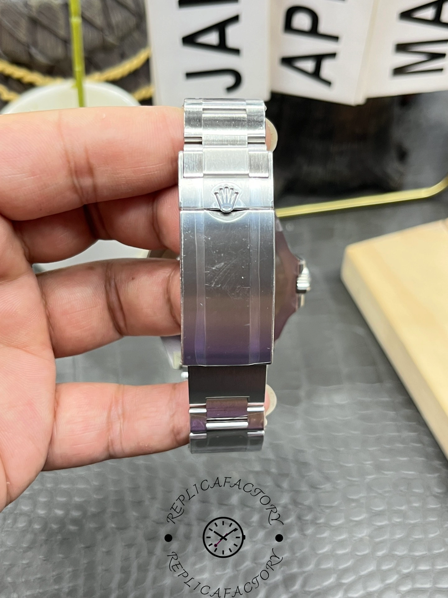 Rolex Sea-Dweller 126600 0002 clasp close-up, stainless steel Oyster bracelet, in hand.