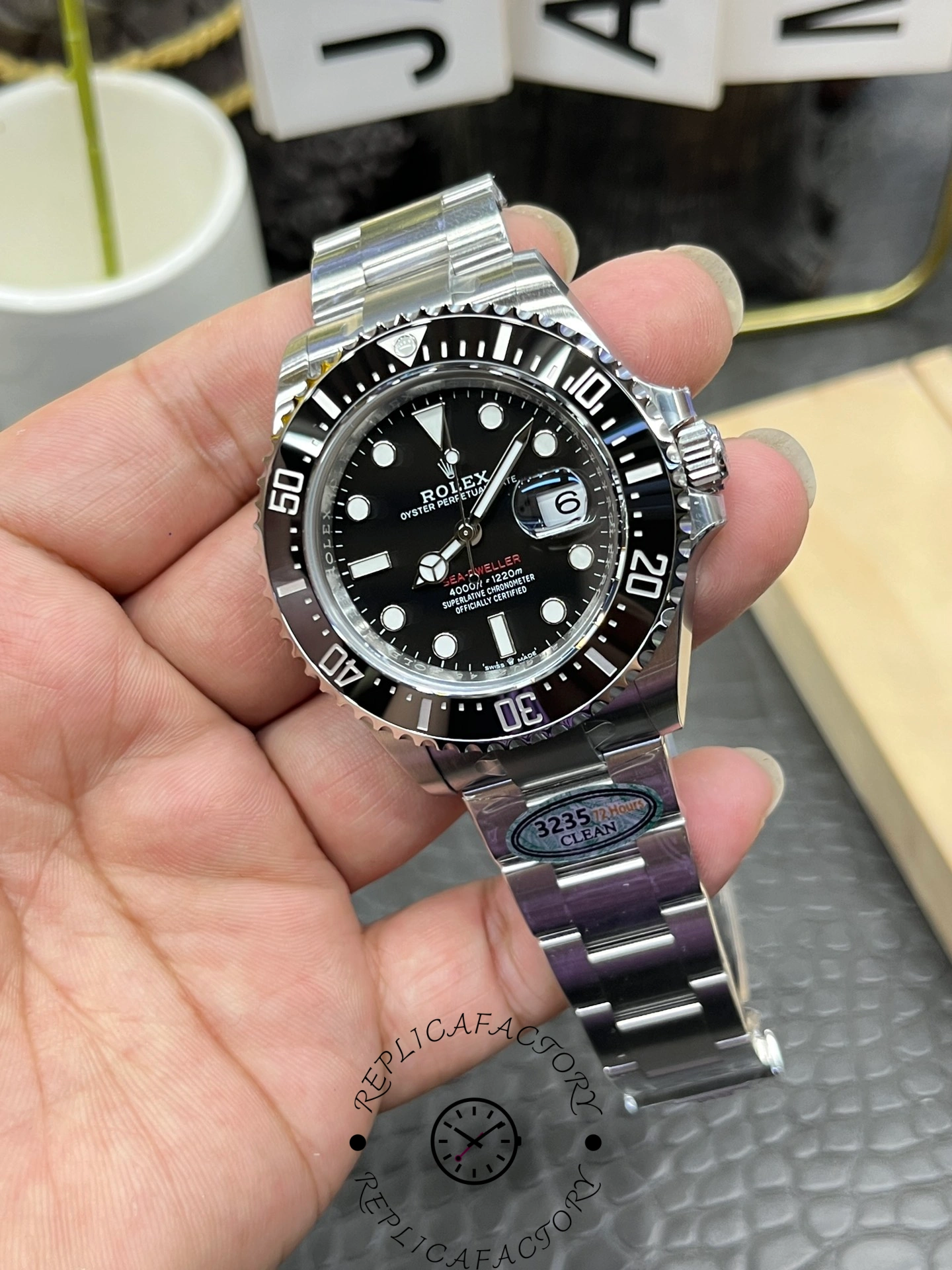 Rolex Sea-Dweller 126600 0002 front angle, black dial details, Oyster bracelet, held in hand.