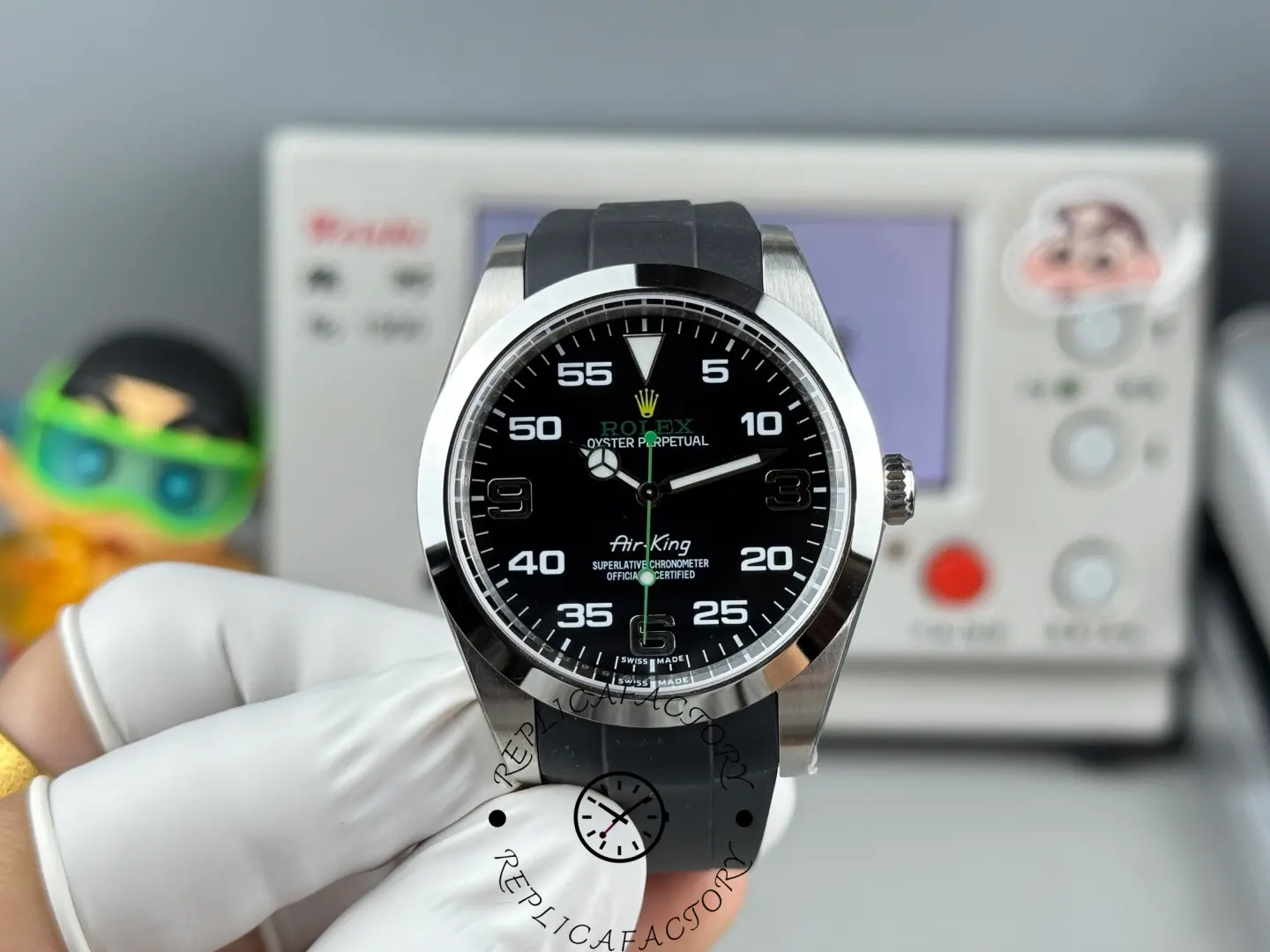 Rolex Air-King 126900 0001, black dial, rubber strap, hand-held front view.