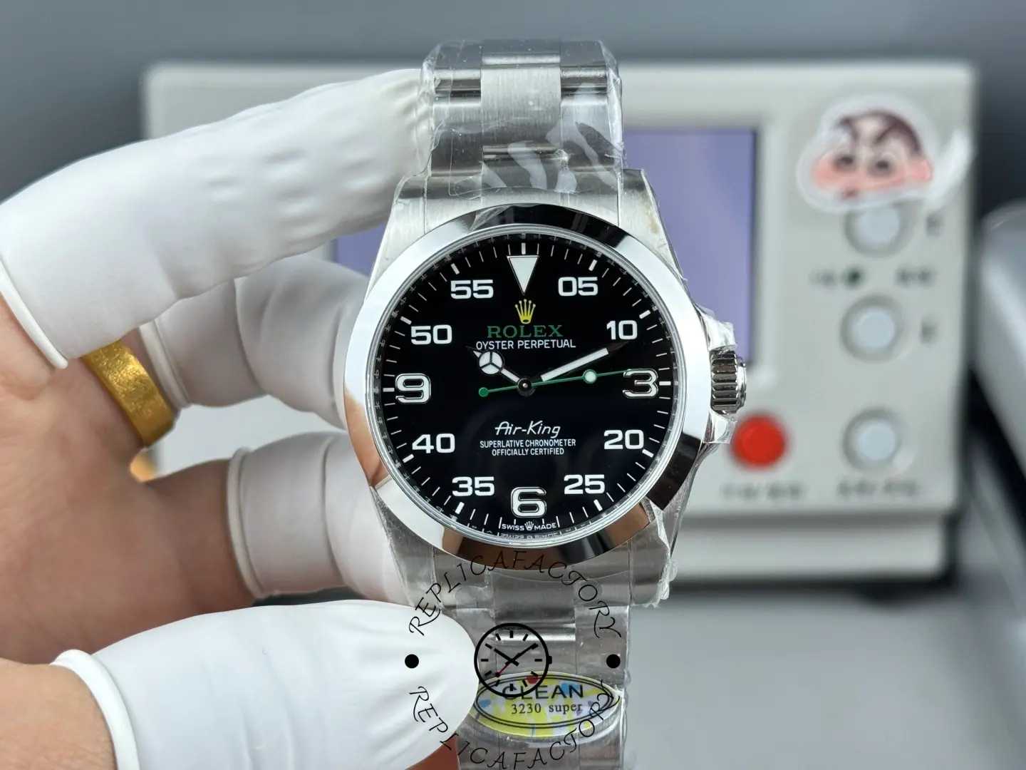 Rolex Air-King 126900 0001, wrist/hand shot showing the black dial and green seconds hand.