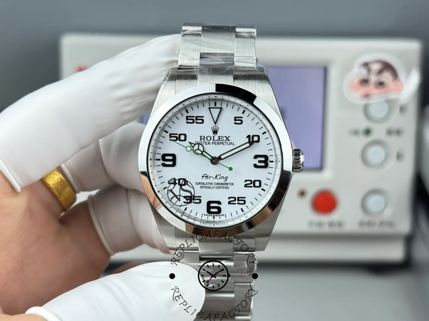 Rolex Air-King 126900 held in gloved hand, white dial, Oyster bracelet, front view.