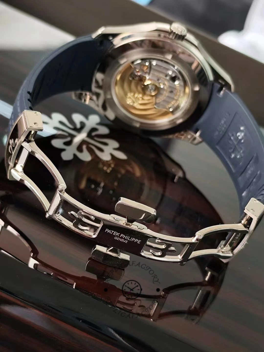 Open clasp view of the Patek Philippe Aquanaut 5164G-001 showing the engraved folding buckle.